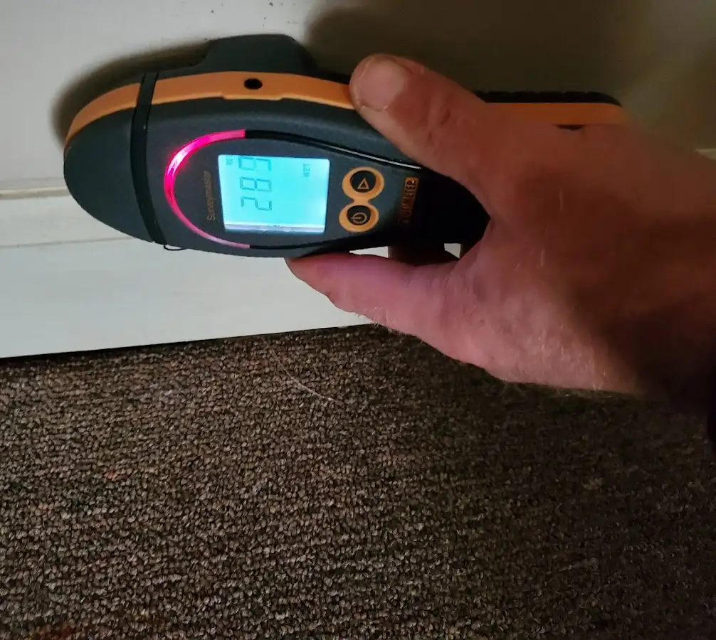 Moisture detection at baseboard during Storm Damage Restoration in Adel
